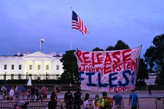A protester holds a sign outside the White House demanding the release of all files related to Jeffrey Epstein in Washington, DC on Friday